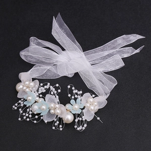 Detailed macro view of bridal flower headband with white pearls and blue petals