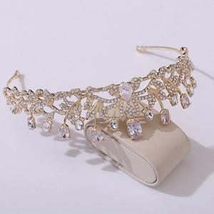 Detailed view of bridal crown featuring gold leaf patterns and sparkling waterdrop crystals