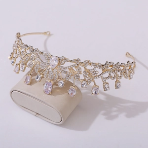 Detail of a bridal crown showing hollow gold leaves with crystal droplets and zircon stones