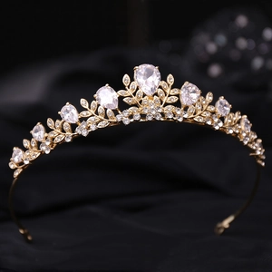 Elegant gold leaf bridal tiara with sparkling rhinestones on a black velvet background