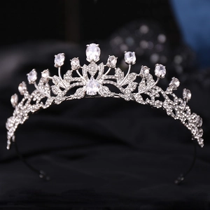 Silver bridal crown with leaf patterns and drop-shaped zircon crystals on black velvet