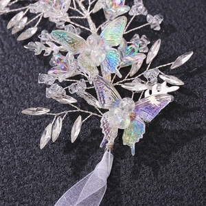 Macro detail of bridal hairband with iridescent butterflies and faceted crystal beads