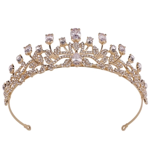 Baroque gold bridal crown with sparkling zircons and leaf patterns on a white background