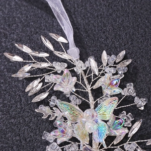 Detailed macro of handmade silver wire butterfly hair piece with iridescent crystals