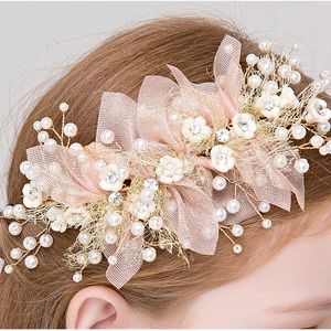 Detail of pink mesh flower hairband with white blossoms and pearls for flower girls