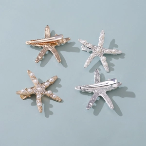 Close-up of starfish hair clips with pearls and rhinestones on gold and silver metal