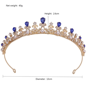 Golden princess tiara with blue gemstones and pearls measuring 13cm wide and 2.6cm high