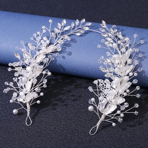 Macro detail of silver leaf bridal headpiece with white pearls and sparkling crystals