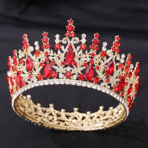 Macro shot of luxury gold bridal crown featuring red marquise crystals and rhinestones