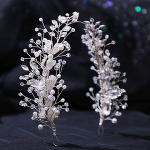 Silver leaf bridal hair vine with pearls and crystals on dark textured fabric background