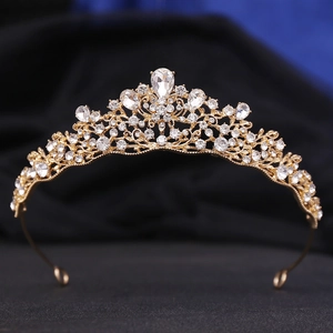 Macro shot of bridal tiara with gold base and intricate pear-shaped clear crystals