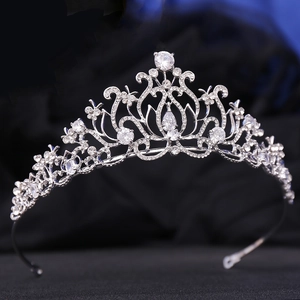 Detailed view of silver bridal crown with lotus diamond pattern and teardrop pendant