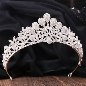 Detailed view of silver wedding tiara with sparkling rhinestones on dark background