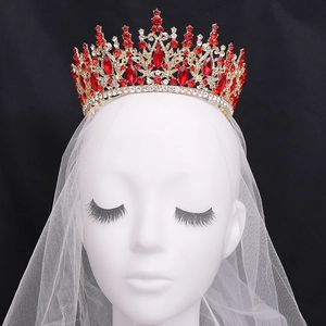 Baroque gold bridal crown featuring large red crystals and rhinestones for weddings