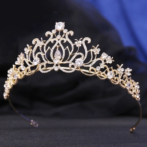 Detail shot of a lotus-shaped gold bridal crown with AAA zircons on velvet background