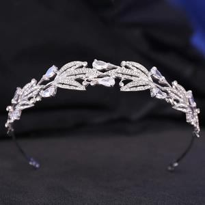 Close-up of silver bridal crown with leaf textures and pear-shaped zircon stones