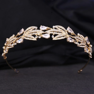 Macro detail of golden bridal tiara featuring leaf motifs and sparkling zircon crystals