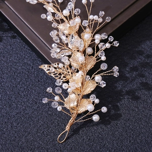 Close-up of golden leaf bridal hairpiece with handmade pearls and sparkling crystals
