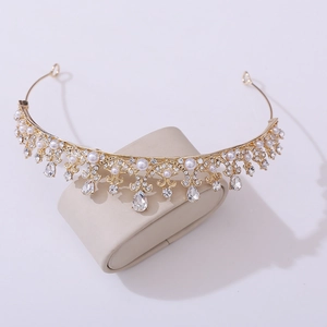 Detailed view of a golden princess crown featuring inlaid pearls and sparkling rhinestones