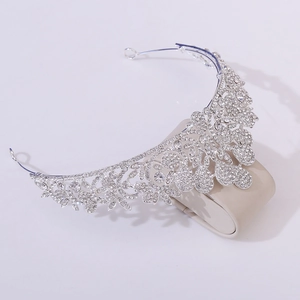 Detailed view of silver crystal bridal tiara crown with floral pattern and rhinestones