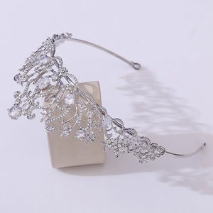 Detailed 45-degree side view of a bridal crown with lotus leaf patterns and white zircons