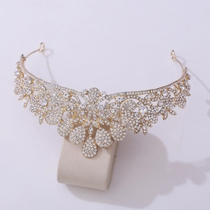 Macro shot of bridal golden alloy tiara featuring white rhinestones and teardrop pendants