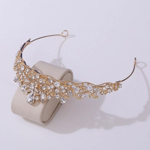 Detailed macro shot of a golden baroque bridal crown featuring sparkling crystal rhinestones