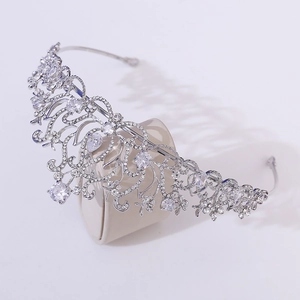 Detailed side view of silver bridal crown featuring lotus patterns and AAA cubic zirconia stones