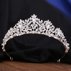 Detailed macro view of a silver bridal crown with clear rhinestones on velvet
