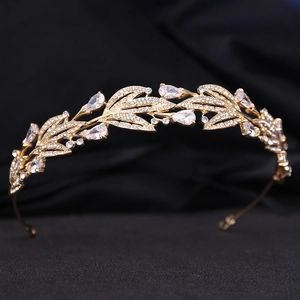 Elegant gold bridal crown with leafy zircon details and pear-shaped rhinestones on black fabric