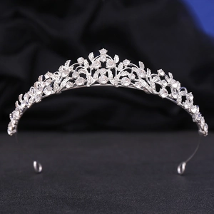Detailed view of silver bridal crown featuring leaf motifs and shimmering crystals