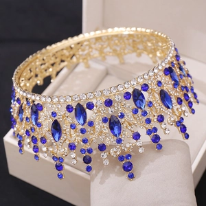 Golden bridal tiara with deep blue crystals and floral motifs in a jewelry display box