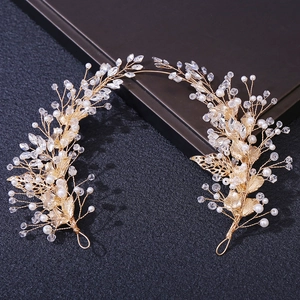 Detailed close-up of golden bridal headband with crystals, pearls and metal leaf design