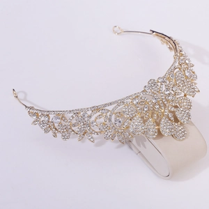 Detailed close-up of golden bridal tiara with sparkling rhinestones and floral patterns