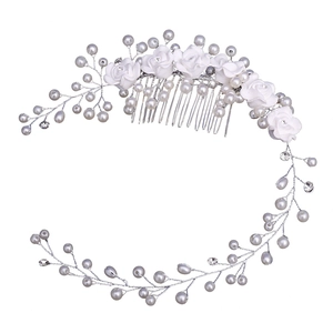 Handmade bridal hair comb with white ceramic flowers, pearls, and crystals for weddings