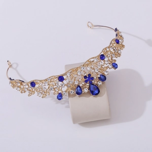 Detail of gold bridal tiara with blue water-drop rhinestones and white crystal accents