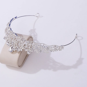 Detailed macro view of a silver baroque tiara with rhinestones and a teardrop pendant