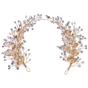 Elegant bridal hair vine with golden leaves, pearls and crystals on white background