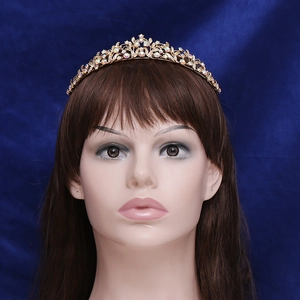 Exquisite golden bridal crown with iridescent rhinestones and floral vine patterns
