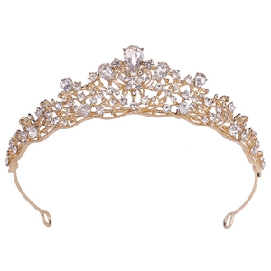 Macro detail of gold baroque bridal crown with crystals and large teardrop rhinestone