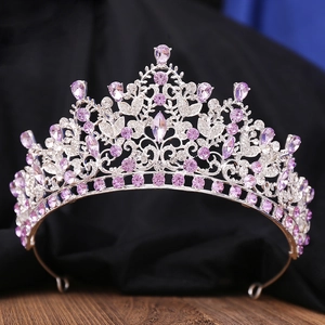 Detailed view of silver bridal crown with purple rhinestones and intricate vine patterns