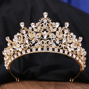 Close-up of luxury gold alloy bridal crown with intricate crystal and rhinestone detailing