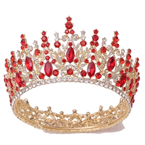 Detailed view of vintage gold bridal crown with red rhinestones and crystal ornaments