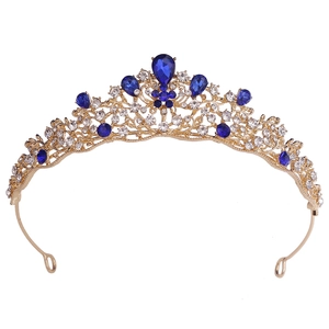 Detailed macro view of baroque gold tiara with blue crystals and sparkling rhinestones