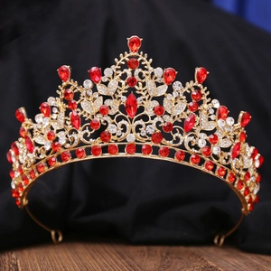 Detailed macro view of luxurious gold tiara with red crystals and white diamonds