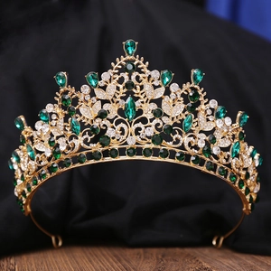 Detail of luxury bridal crown featuring emerald green gems and sparkling crystals