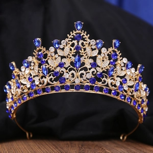 Macro shot of luxury gold tiara with dark blue waterdrop crystals and white diamonds