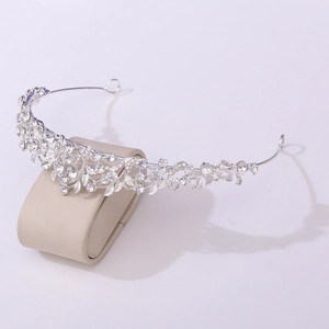 Detail of silver bridal crown featuring marquise rhinestones and leaf pattern design