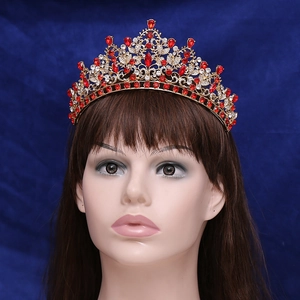 Luxury gold bridal crown with red ruby rhinestones and clear crystals on a radiant frame