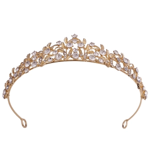 Elegant gold bridal crown featuring intricate floral patterns and crystal rhinestones